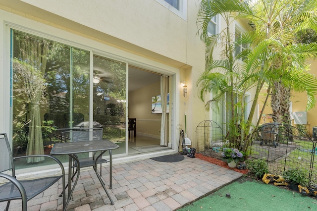 899 Pipers Cay Dr, West Palm Beach, FL 33415 - property entrance featuring stucco siding and a patio area