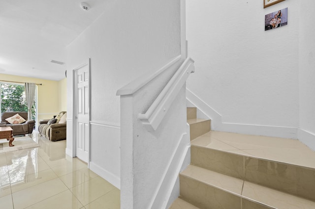 899 Pipers Cay Dr, West Palm Beach, FL 33415 - staircase with tile patterned floors and baseboards