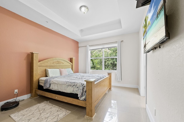 899 Pipers Cay Dr, West Palm Beach, FL 33415 - bedroom with light tile patterned flooring, a raised ceiling, and baseboards