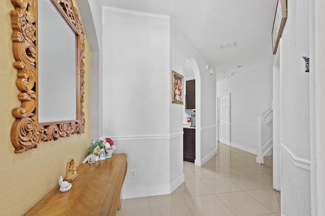 899 Pipers Cay Dr, West Palm Beach, FL 33415 - hall featuring arched walkways, light tile patterned floors, and baseboards