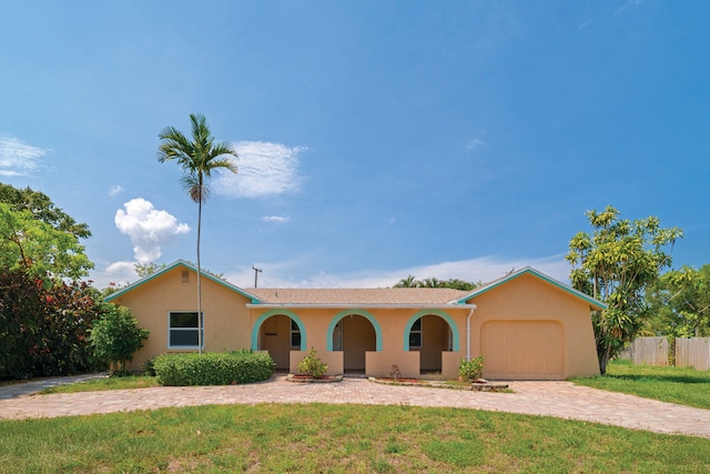 103 E Shannondale Rd E, Cloud Lake, FL 33406 - single story home featuring stucco siding, an attached garage, and decorative driveway