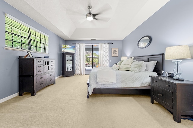 756 SW Pelican Cv, Port Saint Lucie, FL 34986 - bedroom with light carpet, a tray ceiling, a ceiling fan, access to outside, and baseboards