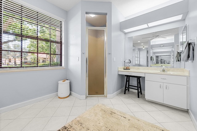 756 SW Pelican Cv, Port Saint Lucie, FL 34986 - bathroom with a skylight, a stall shower, baseboards, tile patterned flooring, and vanity