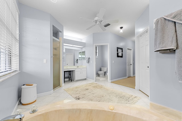 756 SW Pelican Cv, Port Saint Lucie, FL 34986 - full bathroom with toilet, a stall shower, vanity, tile patterned flooring, and ceiling fan