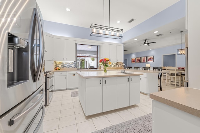 756 SW Pelican Cv, Port Saint Lucie, FL 34986 - kitchen with appliances with stainless steel finishes, light countertops, ceiling fan, tasteful backsplash, and recessed lighting