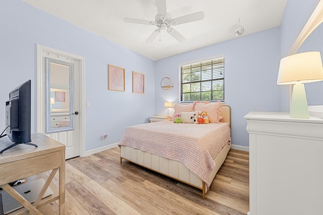 756 SW Pelican Cv, Port Saint Lucie, FL 34986 - bedroom with light wood-style flooring, baseboards, and ceiling fan