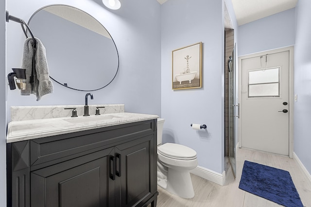 756 SW Pelican Cv, Port Saint Lucie, FL 34986 - bathroom featuring vanity, baseboards, toilet, and a shower with shower door