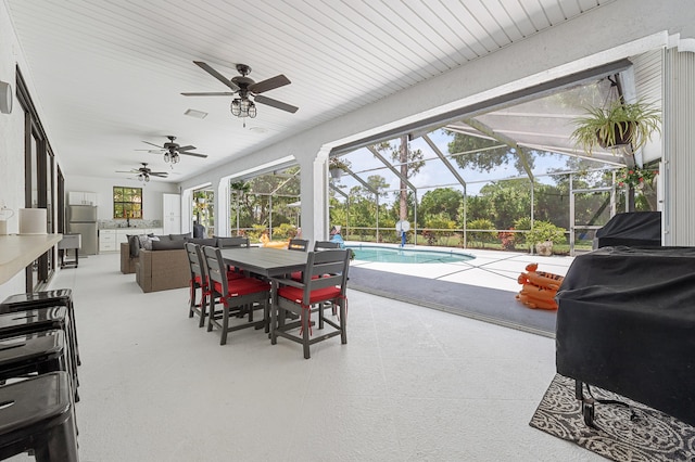 756 SW Pelican Cv, Port Saint Lucie, FL 34986 - view of patio / terrace with ceiling fan, an outdoor pool, outdoor dining area, outdoor lounge area, and glass enclosure