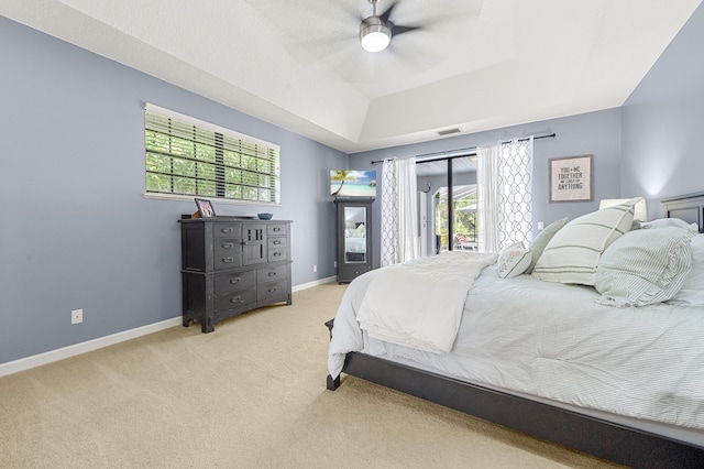 756 SW Pelican Cv, Port Saint Lucie, FL 34986 - bedroom featuring a raised ceiling, access to outside, multiple windows, and light carpet