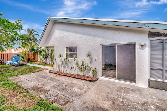 82 Baytree Cir, Boynton Beach, FL 33436 - back of property with stucco siding and a patio