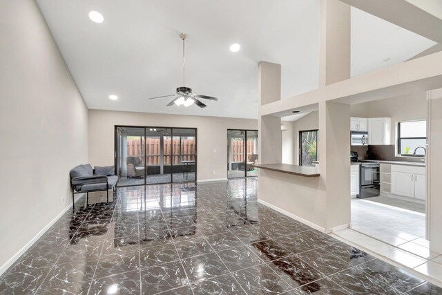 82 Baytree Cir, Boynton Beach, FL 33436 - living room with baseboards, a ceiling fan, light marble finish flooring, recessed lighting, and high vaulted ceiling