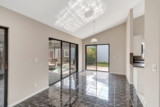 82 Baytree Cir, Boynton Beach, FL 33436 - empty room featuring dark marble finish flooring, lofted ceiling, and baseboards