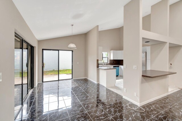 82 Baytree Cir, Boynton Beach, FL 33436 - unfurnished living room with marble tiled flooring, high vaulted ceiling, and baseboards