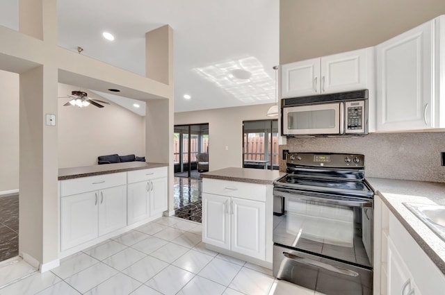 82 Baytree Cir, Boynton Beach, FL 33436 - kitchen featuring stainless steel microwave, black range with electric cooktop, a peninsula, white cabinetry, and a ceiling fan