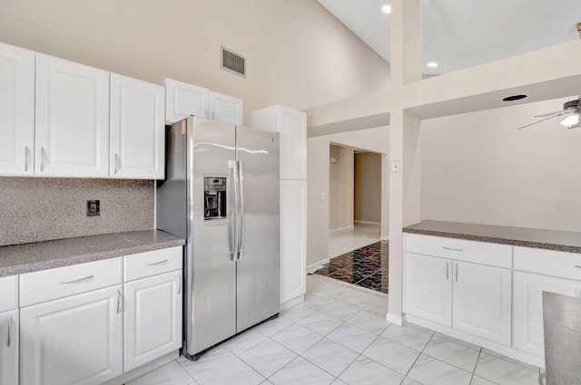 82 Baytree Cir, Boynton Beach, FL 33436 - kitchen with stainless steel fridge with ice dispenser, white cabinets, baseboards, light marble finish flooring, and a high ceiling