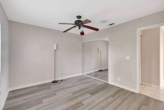 82 Baytree Cir, Boynton Beach, FL 33436 - unfurnished bedroom featuring light wood-style floors, a closet, baseboards, and ceiling fan