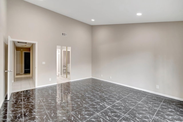 82 Baytree Cir, Boynton Beach, FL 33436 - empty room featuring a towering ceiling, baseboards, marble finish floors, and recessed lighting