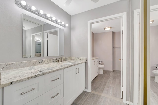 82 Baytree Cir, Boynton Beach, FL 33436 - bathroom featuring toilet, vanity, and a ceiling fan