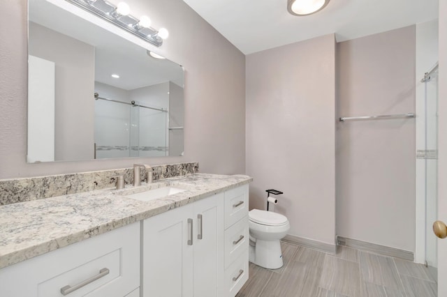 82 Baytree Cir, Boynton Beach, FL 33436 - bathroom with a shower with door, toilet, vanity, and baseboards
