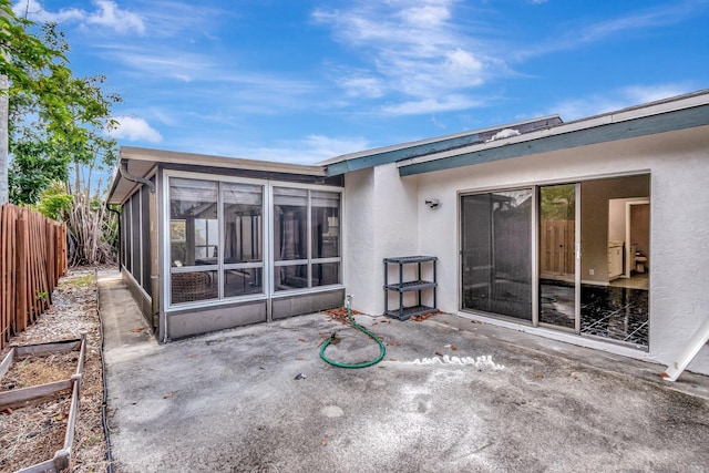 82 Baytree Cir, Boynton Beach, FL 33436 - back of house featuring a patio, stucco siding, and a sunroom