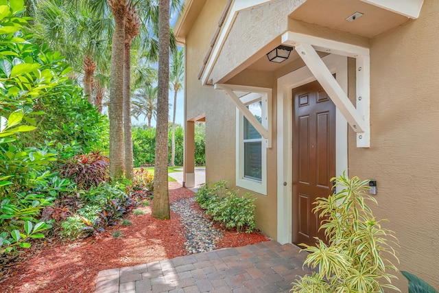5030 Dulce Ct, Palm Beach Gardens, FL 33418 - view of exterior entry with stucco siding