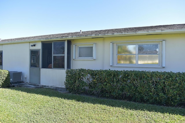 2597 Emory Dr W Unit G, West Palm Beach, FL 33415 - view of side of property featuring cooling unit and a lawn