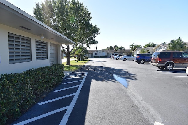2597 Emory Dr W Unit G, West Palm Beach, FL 33415 - uncovered parking lot featuring a residential view