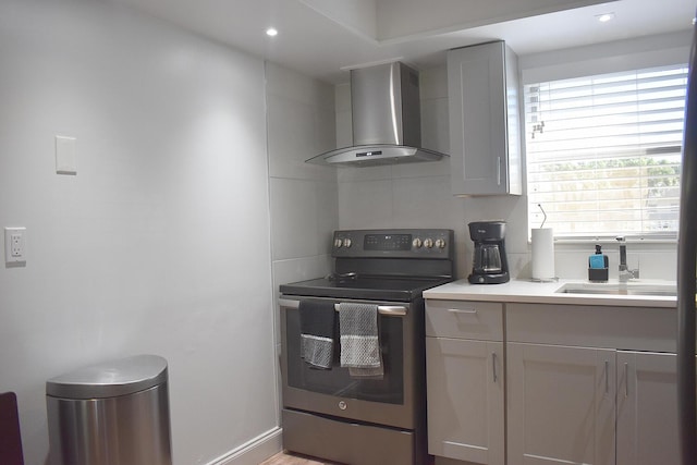 2597 Emory Dr W Unit G, West Palm Beach, FL 33415 - kitchen with wall chimney exhaust hood, stainless steel electric stove, a sink, light countertops, and recessed lighting