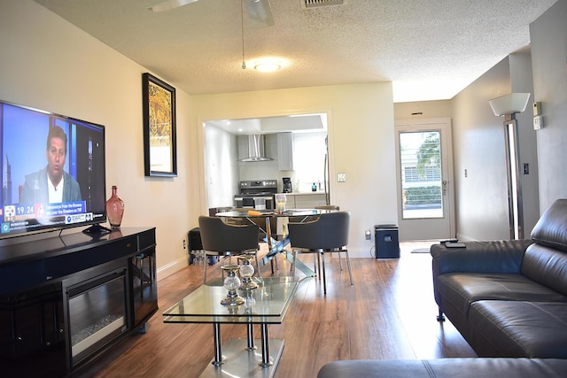2597 Emory Dr W Unit G, West Palm Beach, FL 33415 - living room featuring wood finished floors, a textured ceiling, baseboards, and ceiling fan