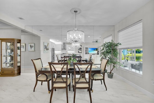11454 SW Hawkins Ter, Port Saint Lucie, FL 34987 - dining room with light marble finish flooring and a chandelier