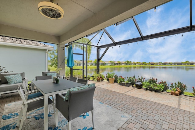 11454 SW Hawkins Ter, Port Saint Lucie, FL 34987 - view of patio / terrace with a water view, glass enclosure, and outdoor dining space