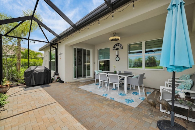 11454 SW Hawkins Ter, Port Saint Lucie, FL 34987 - view of patio / terrace with a grill, outdoor dining space, and glass enclosure