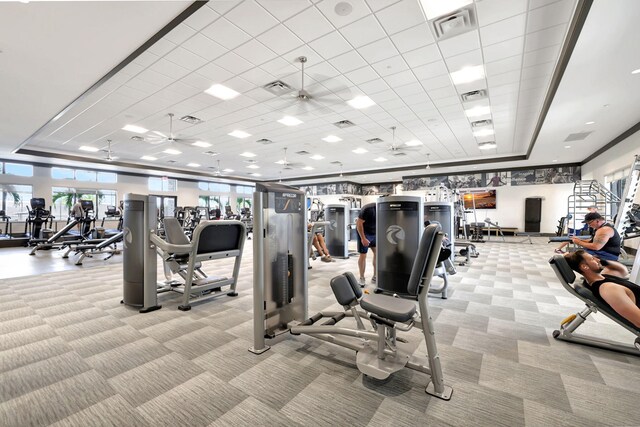 11454 SW Hawkins Ter, Port Saint Lucie, FL 34987 - gym with light colored carpet, a ceiling fan, a tray ceiling, and a paneled ceiling