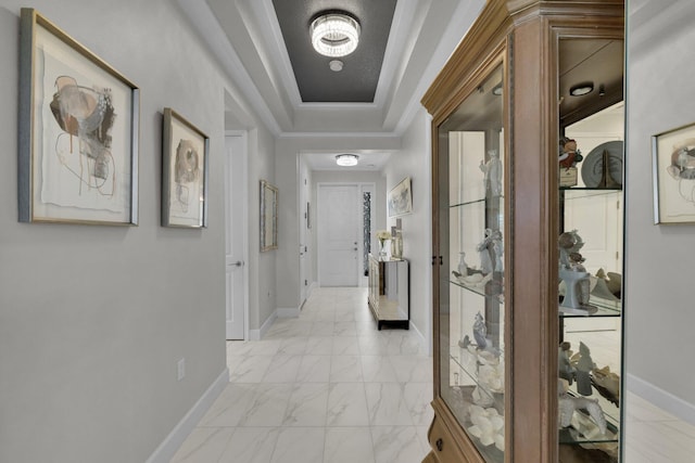 11454 SW Hawkins Ter, Port Saint Lucie, FL 34987 - corridor featuring light marble finish flooring, a tray ceiling, and crown molding
