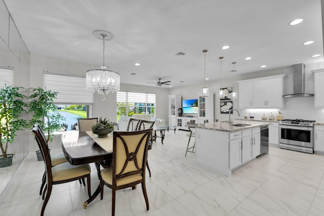 11454 SW Hawkins Ter, Port Saint Lucie, FL 34987 - dining area featuring a chandelier, recessed lighting, a ceiling fan, and light marble finish flooring
