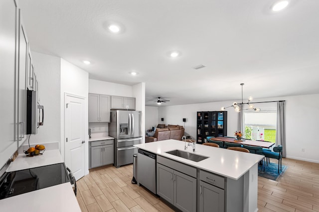 956 Bent Creek Dr, Fort Pierce, FL 34947 - kitchen featuring stainless steel appliances, gray cabinetry, a sink, wood tiled floors, and light countertops