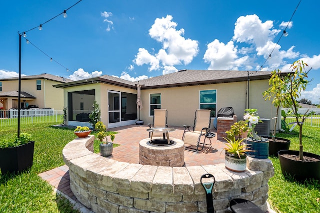 956 Bent Creek Dr, Fort Pierce, FL 34947 - back of property featuring a sunroom, a patio area, an outdoor fire pit, stucco siding, and central air condition unit