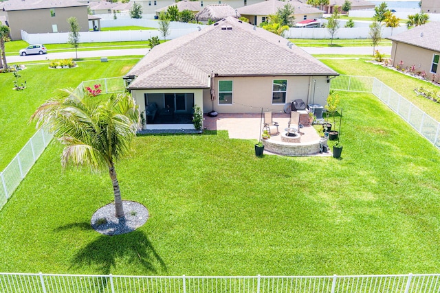 956 Bent Creek Dr, Fort Pierce, FL 34947 - rear view of house with a patio, a shingled roof, stucco siding, and a residential view