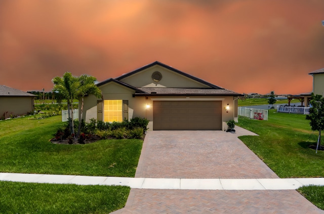 956 Bent Creek Dr, Fort Pierce, FL 34947 - ranch-style home featuring decorative driveway, a front yard, stucco siding, and an attached garage