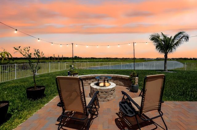 956 Bent Creek Dr, Fort Pierce, FL 34947 - patio terrace at dusk with a fire pit, a patio area, and a water view
