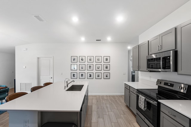 956 Bent Creek Dr, Fort Pierce, FL 34947 - kitchen featuring appliances with stainless steel finishes, a sink, gray cabinetry, light countertops, and recessed lighting