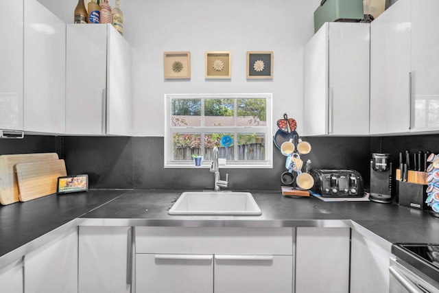 1005 SW 15th Ter, Fort Lauderdale, FL 33312 - kitchen with a sink, white cabinetry, backsplash, and stainless steel electric stove