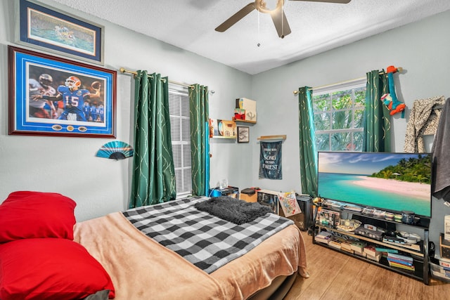 1005 SW 15th Ter, Fort Lauderdale, FL 33312 - bedroom with wood finished floors, a ceiling fan, and a textured ceiling