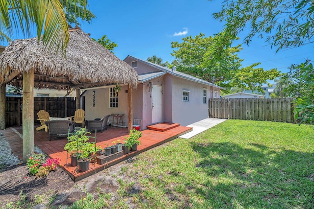 1005 SW 15th Ter, Fort Lauderdale, FL 33312 - back of property with stucco siding, a wooden deck, and a gazebo