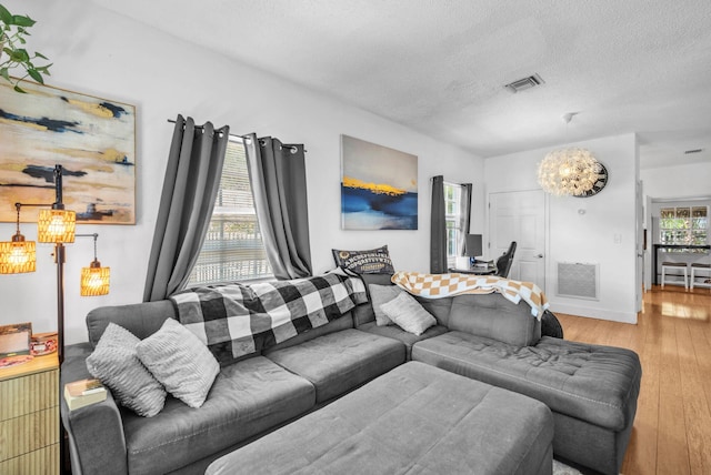1005 SW 15th Ter, Fort Lauderdale, FL 33312 - living area with a textured ceiling, wood finished floors, and a chandelier