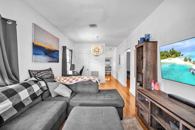 1005 SW 15th Ter, Fort Lauderdale, FL 33312 - living room with light wood-style floors and a textured ceiling