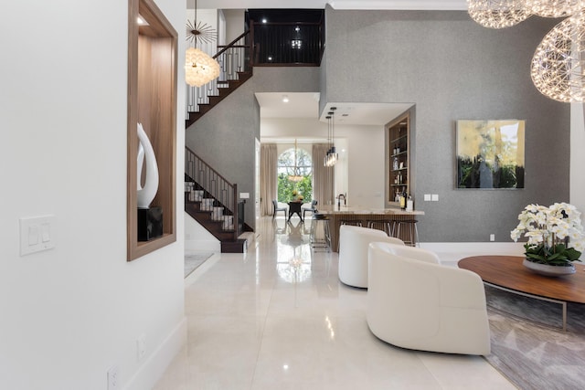 17725 Circle Pond Ct, Boca Raton, FL 33496 - entrance foyer with stairs, a towering ceiling, light tile patterned floors, a chandelier, and baseboards