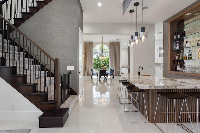 17725 Circle Pond Ct, Boca Raton, FL 33496 - bar area featuring a sink, stairway, a chandelier, tile patterned floors, and built in features