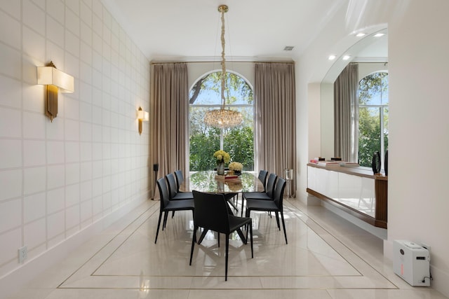 17725 Circle Pond Ct, Boca Raton, FL 33496 - dining area with a chandelier, tile walls, inlaid floor details, and healthy amount of natural light
