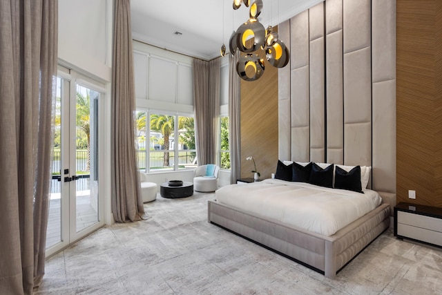 17725 Circle Pond Ct, Boca Raton, FL 33496 - bedroom featuring access to exterior, a chandelier, and wooden walls